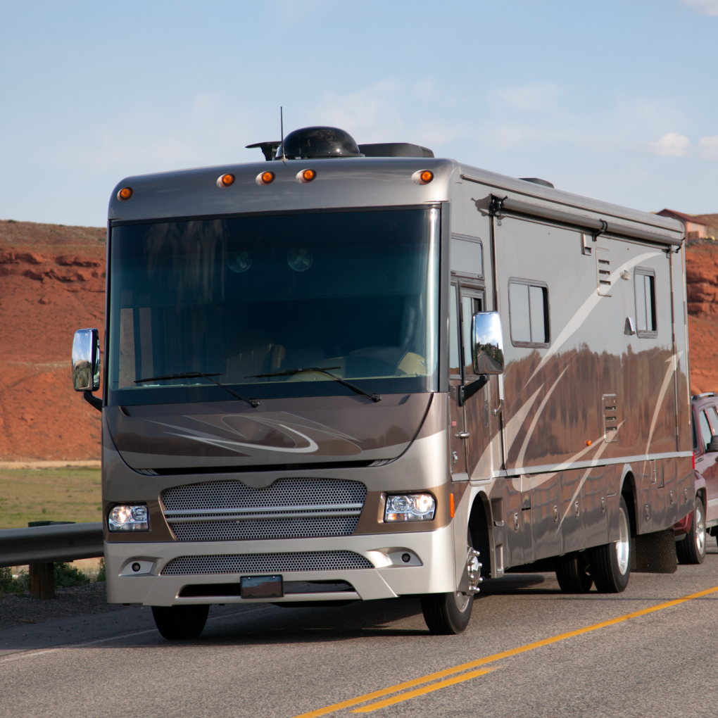 Motorhome Driving on Road by Red Rock Formation